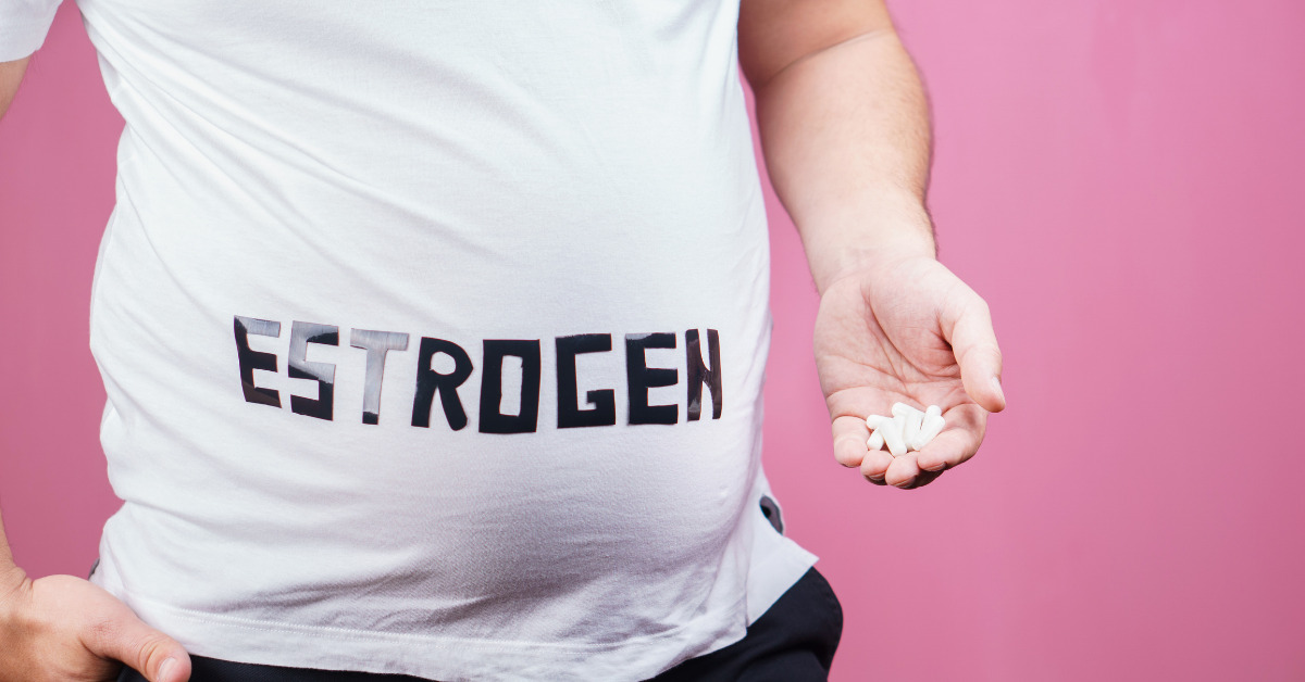 Person wearing a white shirt with estrogen written on it taking estrogen inhibitor pills