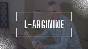 Man Holding L-arginine pill bottles